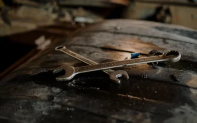 Close-up view of wrenches placed on a textured surface in a workshop setting.