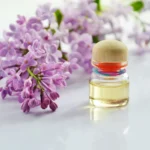 Glass bottle of lavender essential oil with fresh flowers, perfect for aromatherapy and relaxation.