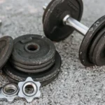 Weathered heavy adjustable dumbbell with details for regulating weight for muscle training on paved ground