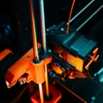 A colorful close-up of a 3D printer operating, showcasing mechanical precision and technology.