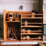 A charming bakery scene featuring assorted breads on wooden shelves with rustic decor.