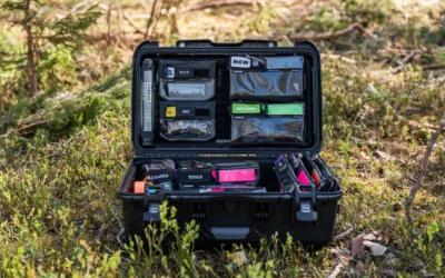 Open hard case filled with camera gear and tools in a forest setting, Sundsvall, Sweden.